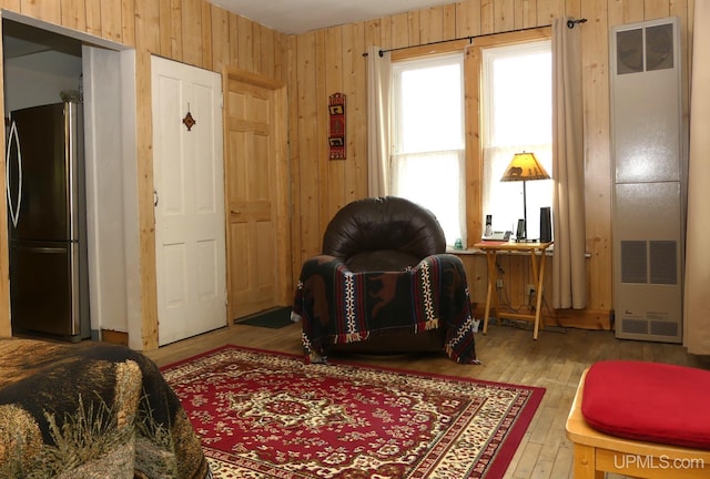 22019 E Everett Ave, Grand Marais, MI 49839 - sitting room featuring a heating unit, wood finished floors, and wood walls