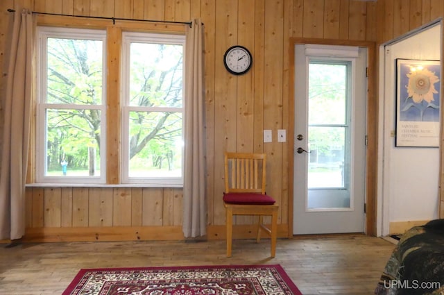 22019 E Everett Ave, Grand Marais, MI 49839 - doorway featuring hardwood / wood-style floors, wooden walls, and healthy amount of natural light
