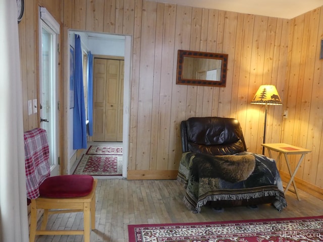 22019 E Everett Ave, Grand Marais, MI 49839 - living area featuring hardwood / wood-style floors, wooden walls, and baseboards