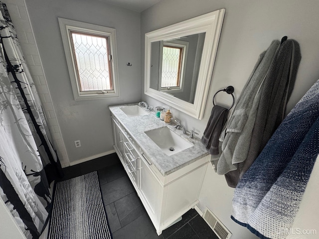 809 W A St, Iron Mountain, MI 49801 - full bath featuring double vanity, tile patterned floors, and baseboards