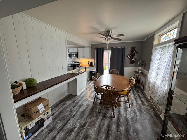 809 W A St, Iron Mountain, MI 49801 - dining area with dark wood-type flooring, crown molding, and a ceiling fan