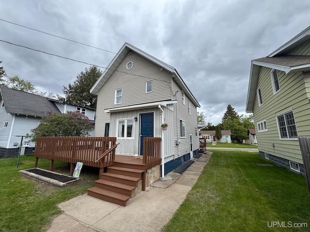 809 W A St, Iron Mountain, MI 49801 - rear view of property with board and batten siding, a deck, and a yard