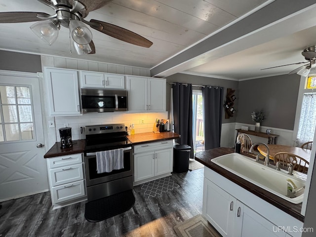 809 W A St, Iron Mountain, MI 49801 - kitchen with appliances with stainless steel finishes, ceiling fan, a sink, dark wood finished floors, and backsplash