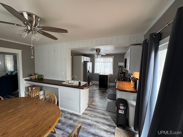 809 W A St, Iron Mountain, MI 49801 - kitchen with ceiling fan, dark wood-style floors, a sink, stainless steel refrigerator with ice dispenser, and crown molding