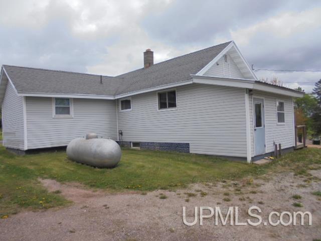 605 W 5th St, Rockland, MI 49960 - rear view of property featuring a chimney and a lawn