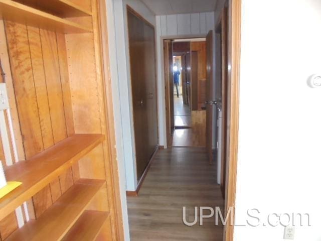 605 W 5th St, Rockland, MI 49960 - hall featuring wood finished floors and wood walls