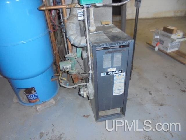 605 W 5th St, Rockland, MI 49960 - utility room featuring a heating unit