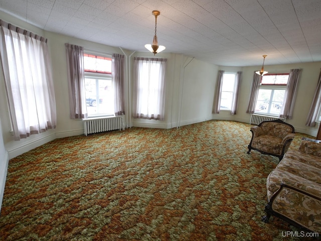 708 Calumet St, Lake Linden, MI 49945 - unfurnished living room featuring radiator, carpet floors, and baseboards