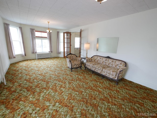 708 Calumet St, Lake Linden, MI 49945 - living area featuring radiator, carpet floors, and baseboards