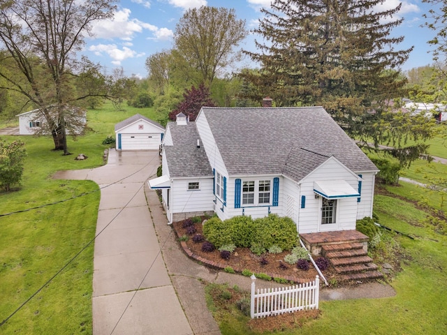 107 State Park Dr, Bay City, MI 48706 - view of front facade with an outdoor structure, roof with shingles, a chimney, a garage, and a front lawn