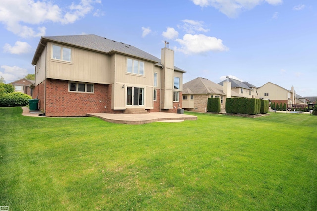 51461 Silver Bell Dr, Macomb Twp, MI 48042 - rear view of property featuring a patio area, brick siding, a lawn, and a chimney