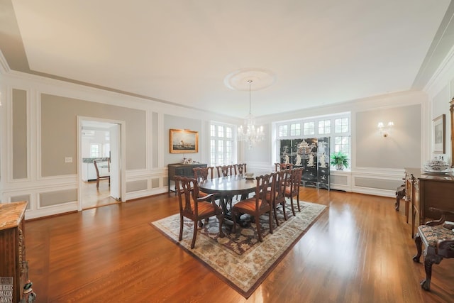 257 Ridge Rd, Grosse Pointe Farms, MI 48236 - dining space with a decorative wall, ornamental molding, a chandelier, dark wood finished floors, and wainscoting
