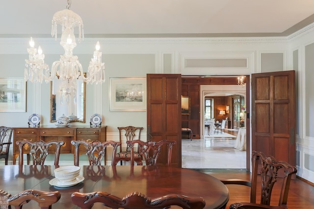 257 Ridge Rd, Grosse Pointe Farms, MI 48236 - dining area with a decorative wall, arched walkways, crown molding, and a chandelier