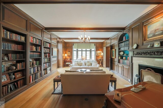 257 Ridge Rd, Grosse Pointe Farms, MI 48236 - living area with light wood-style flooring, a premium fireplace, a chandelier, built in features, and crown molding