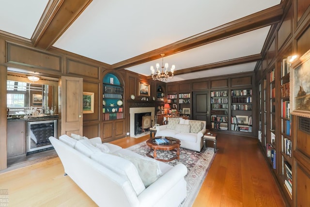 257 Ridge Rd, Grosse Pointe Farms, MI 48236 - living area with wine cooler, a chandelier, wood finished floors, a fireplace with flush hearth, and beamed ceiling