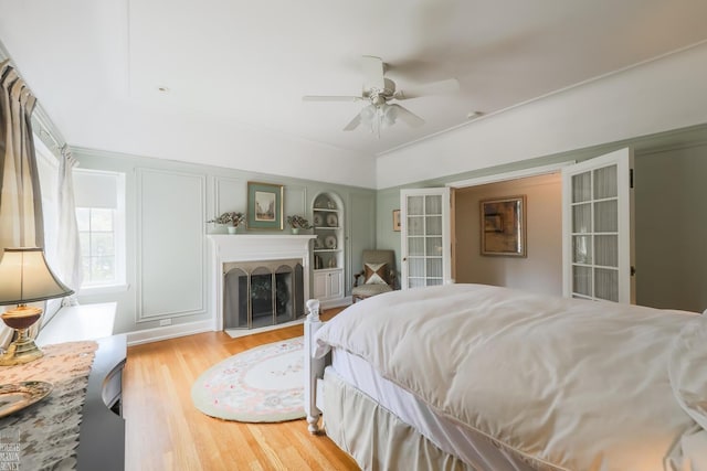 257 Ridge Rd, Grosse Pointe Farms, MI 48236 - bedroom featuring wood finished floors, a fireplace, and a ceiling fan