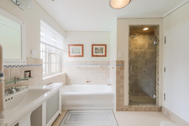 257 Ridge Rd, Grosse Pointe Farms, MI 48236 - full bathroom with tile walls, a garden tub, a shower stall, wainscoting, and tile patterned floors