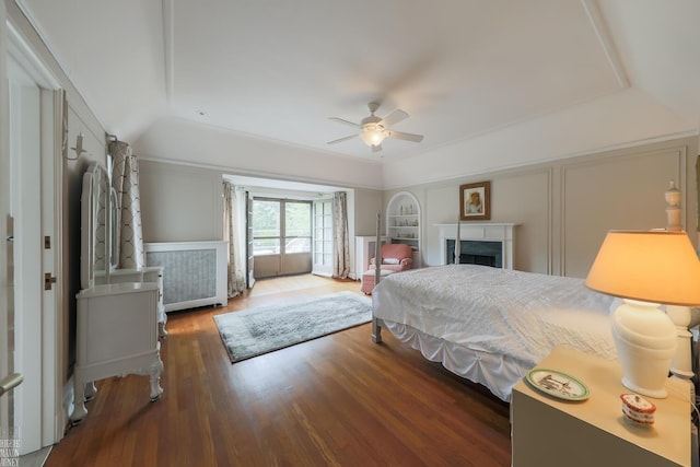 257 Ridge Rd, Grosse Pointe Farms, MI 48236 - bedroom with vaulted ceiling, wood finished floors, a fireplace, a decorative wall, and a ceiling fan