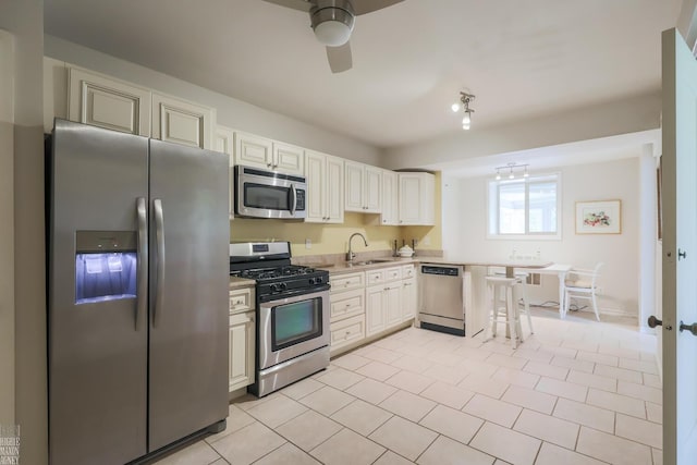 257 Ridge Rd, Grosse Pointe Farms, MI 48236 - kitchen with appliances with stainless steel finishes, ceiling fan, light countertops, light tile patterned floors, and a sink