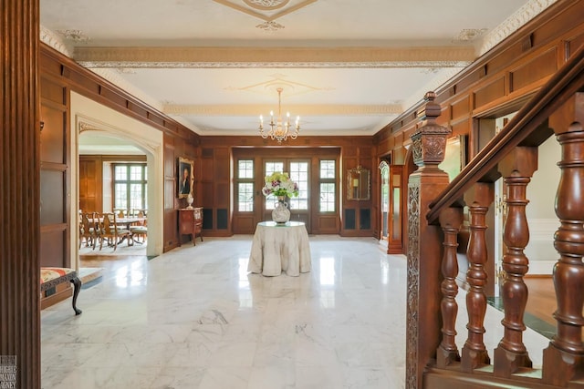 257 Ridge Rd, Grosse Pointe Farms, MI 48236 - foyer entrance with arched walkways, light marble finish floors, a chandelier, wooden walls, and a decorative wall