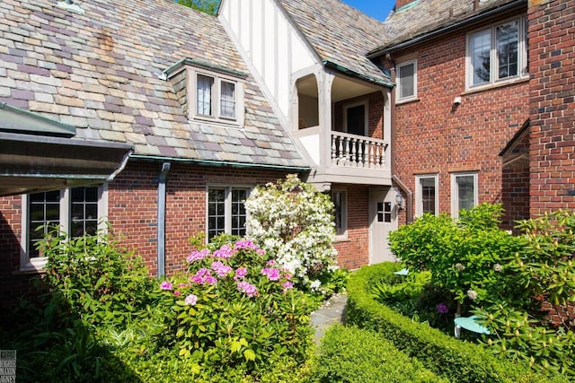 257 Ridge Rd, Grosse Pointe Farms, MI 48236 - view of side of property with a high end roof, a chimney, and brick siding