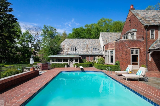 257 Ridge Rd, Grosse Pointe Farms, MI 48236 - view of swimming pool featuring a patio, an exterior structure, and an outbuilding