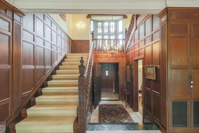 257 Ridge Rd, Grosse Pointe Farms, MI 48236 - stairway featuring a decorative wall and a towering ceiling