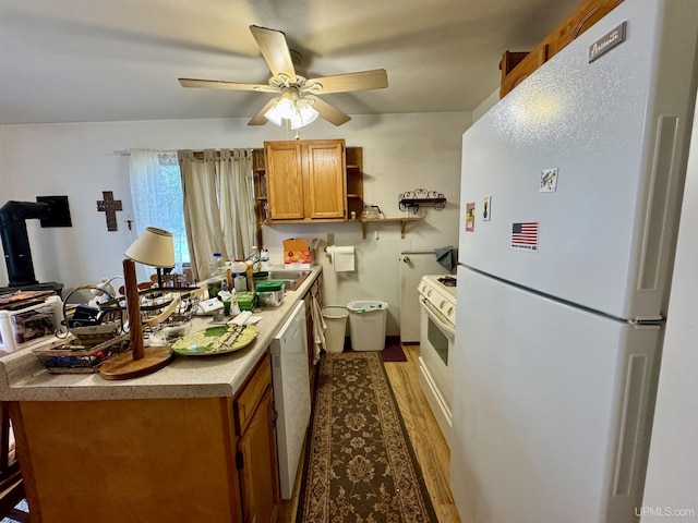 7848 Cole St, Rapid River, MI 49878 - kitchen with white appliances, open shelves, a sink, brown cabinetry, and ceiling fan