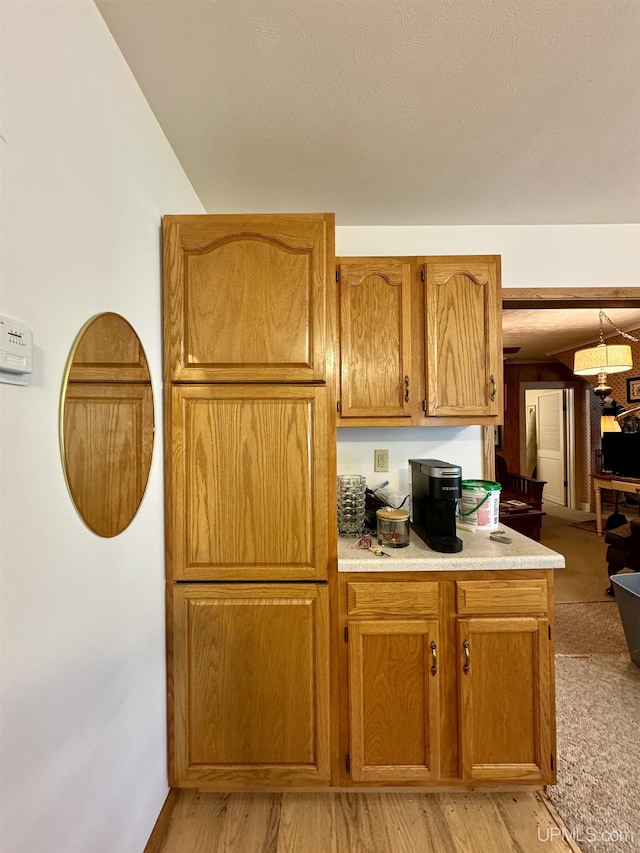 7848 Cole St, Rapid River, MI 49878 - kitchen with light countertops, brown cabinetry, and light wood finished floors