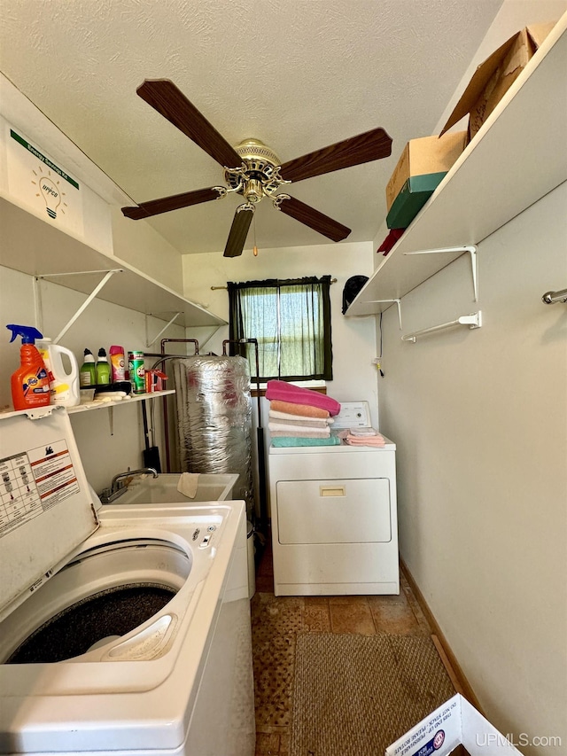 7848 Cole St, Rapid River, MI 49878 - laundry area featuring separate washer and dryer, a ceiling fan, tile patterned flooring, and a textured ceiling