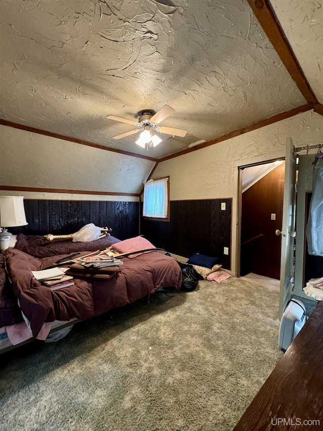7848 Cole St, Rapid River, MI 49878 - bedroom featuring lofted ceiling, carpet floors, a textured wall, a textured ceiling, and wood walls