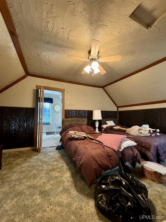 7848 Cole St, Rapid River, MI 49878 - bedroom with lofted ceiling, carpet floors, ceiling fan, wooden walls, and a textured ceiling