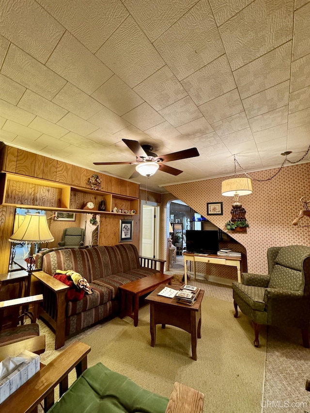 7848 Cole St, Rapid River, MI 49878 - carpeted living room with wooden walls and a ceiling fan
