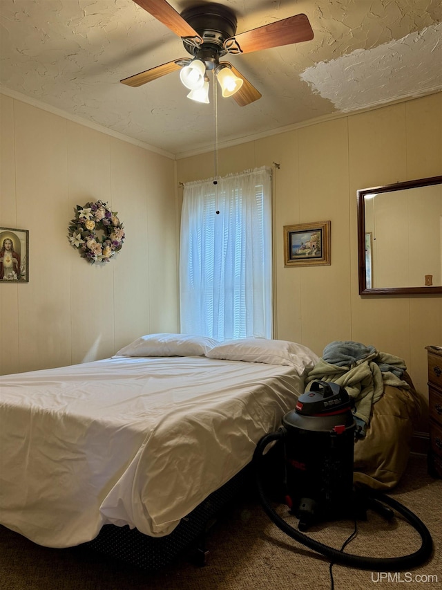 7848 Cole St, Rapid River, MI 49878 - bedroom featuring a decorative wall, crown molding, ceiling fan, and carpet