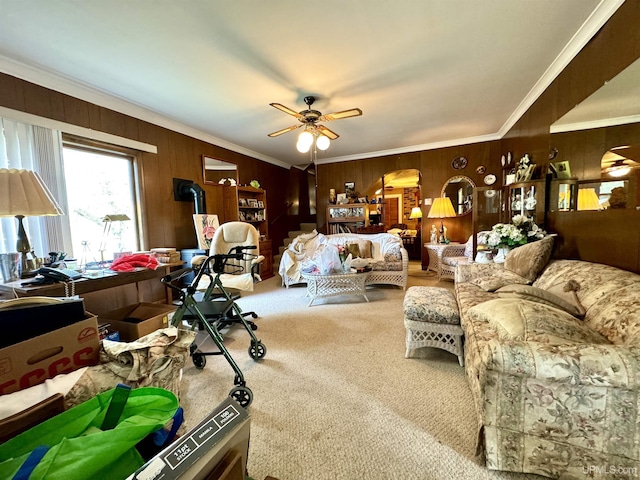 7848 Cole St, Rapid River, MI 49878 - carpeted living room with crown molding, wooden walls, and a ceiling fan