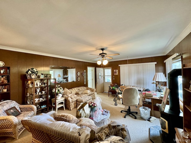 7848 Cole St, Rapid River, MI 49878 - living area with light colored carpet, ceiling fan, wood walls, ornamental molding, and a wood stove