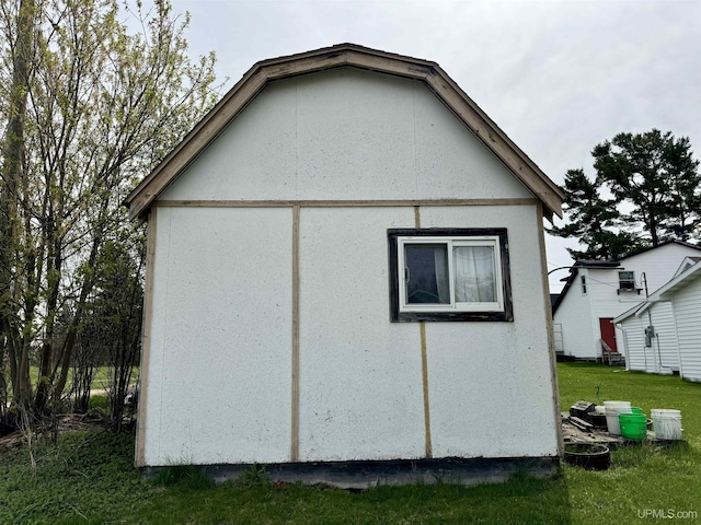 7848 Cole St, Rapid River, MI 49878 - view of home's exterior featuring a lawn