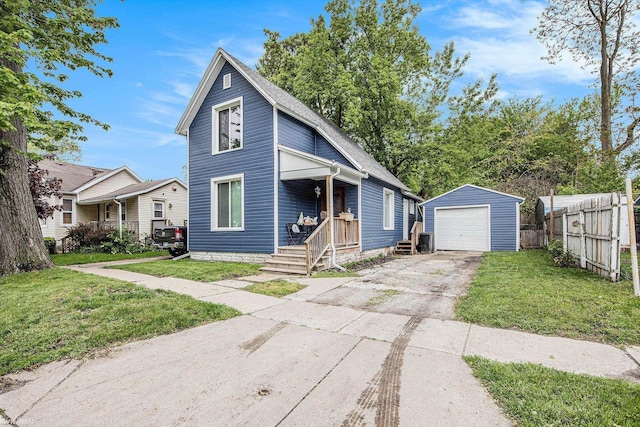 1310 9th St, Port Huron, MI 48060 - view of front of house with an outbuilding, driveway, a porch, and a detached garage