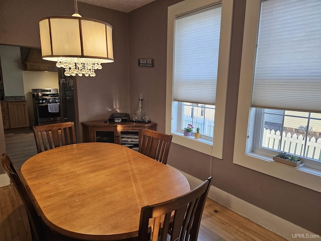 968 Baldwin Ave, Negaunee, MI 49866 - dining room with dark wood-style floors, baseboards, and a chandelier