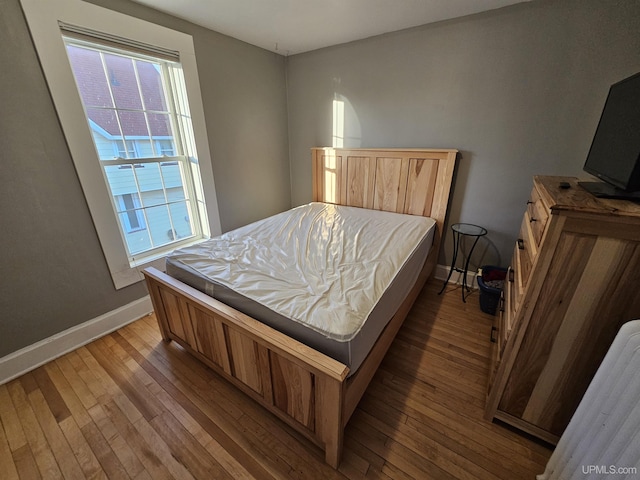 968 Baldwin Ave, Negaunee, MI 49866 - bedroom featuring hardwood / wood-style flooring and baseboards