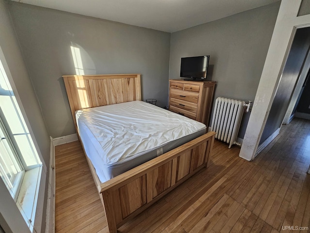 968 Baldwin Ave, Negaunee, MI 49866 - bedroom with radiator, hardwood / wood-style floors, and baseboards