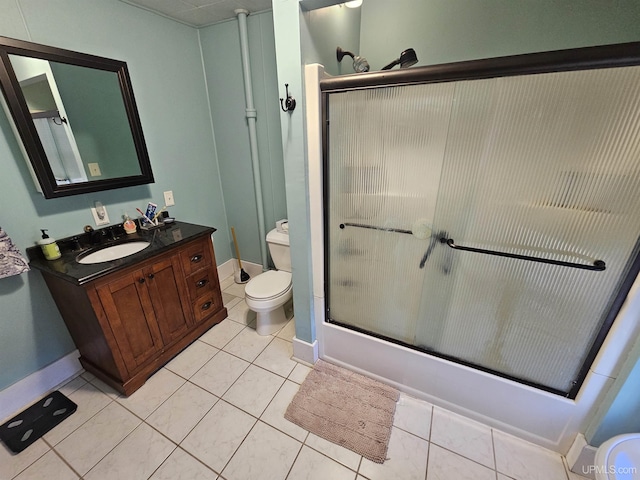 968 Baldwin Ave, Negaunee, MI 49866 - bathroom featuring toilet, vanity, enclosed tub / shower combo, tile patterned floors, and baseboards
