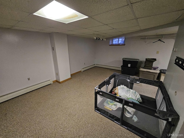 968 Baldwin Ave, Negaunee, MI 49866 - basement with carpet flooring, a paneled ceiling, baseboard heating, a baseboard radiator, and baseboards