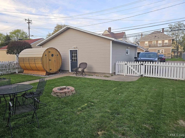 968 Baldwin Ave, Negaunee, MI 49866 - rear view of house featuring a fire pit