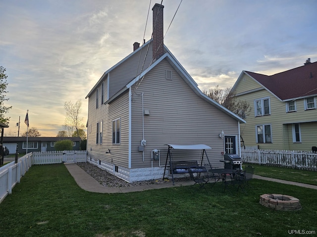 968 Baldwin Ave, Negaunee, MI 49866 - back of house with a fire pit and a chimney