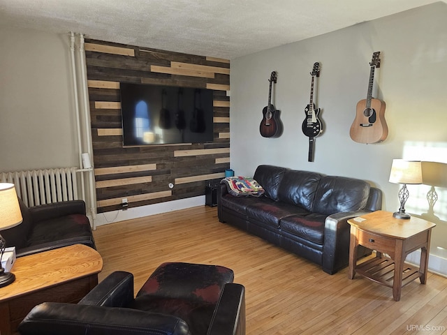 968 Baldwin Ave, Negaunee, MI 49866 - living area with radiator heating unit, wood finished floors, and wooden walls