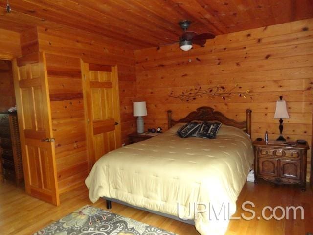 1417 Nestor St, Munising, MI 49862 - bedroom featuring wood finished floors and wooden walls