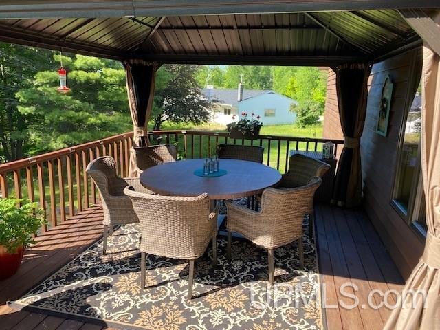 1417 Nestor St, Munising, MI 49862 - wooden deck featuring a gazebo and outdoor dining space