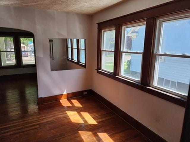 2515 Cooper St, Saginaw, MI 48602 - unfurnished room featuring baseboards, dark wood-style flooring, and a textured ceiling