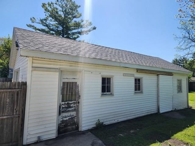 2515 Cooper St, Saginaw, MI 48602 - view of property exterior with a shingled roof and an outbuilding